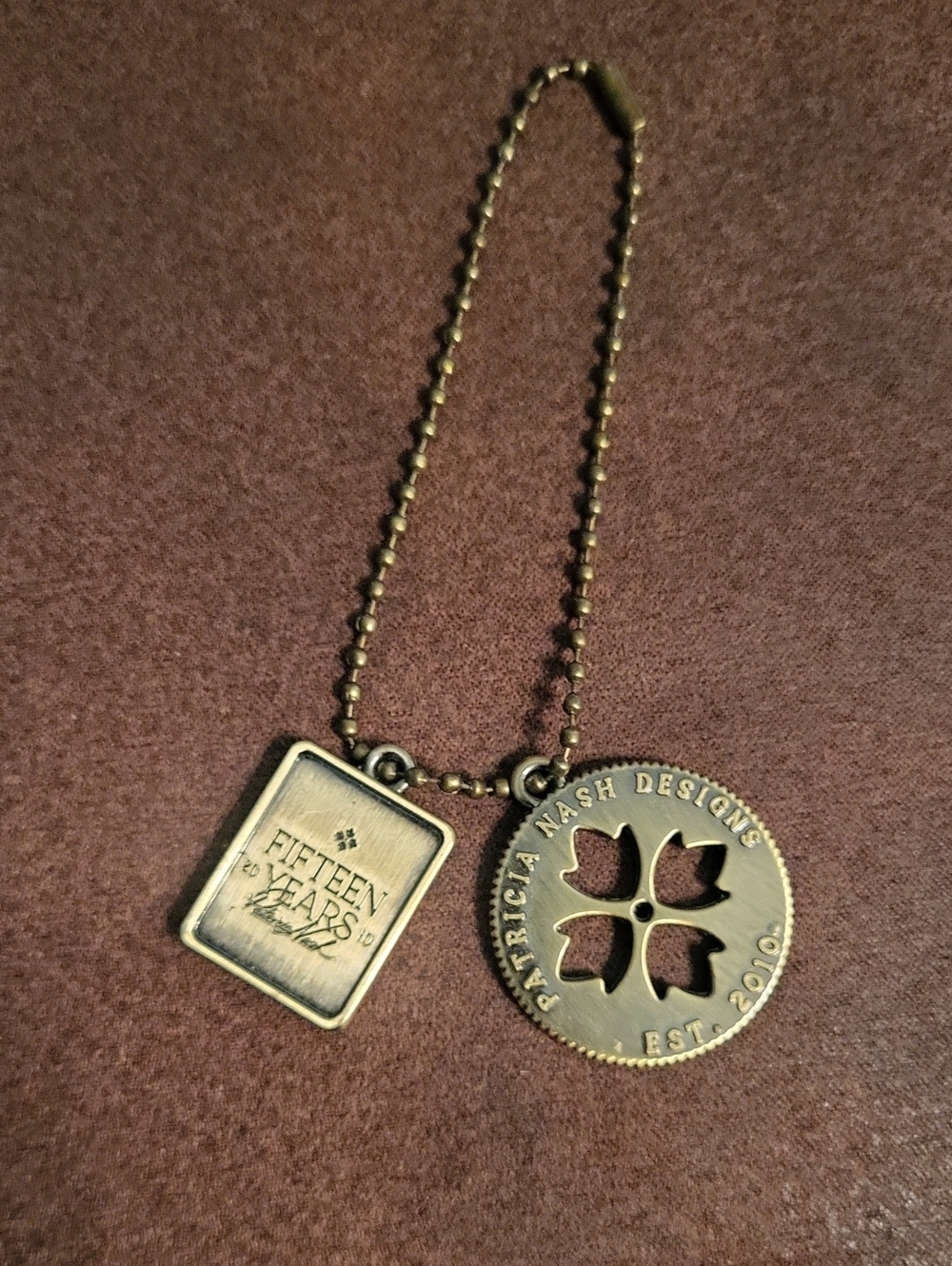 Patricia Nash 15th Anniversary Medallion Bag Charm Brass Tone